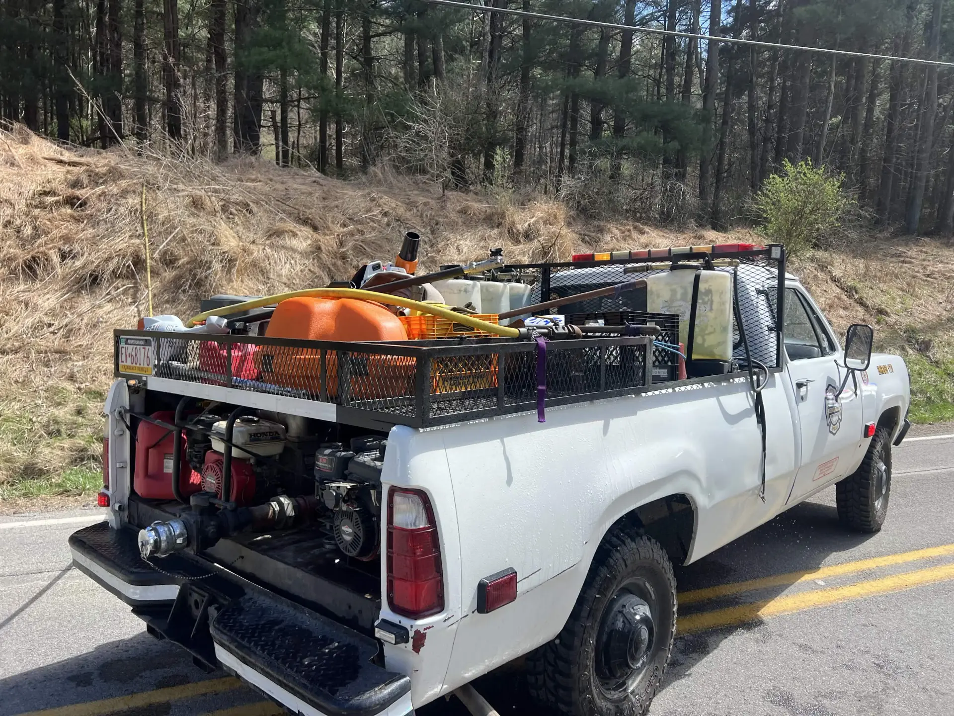Department brush unit loaded with portable pumps, hose and water tanks