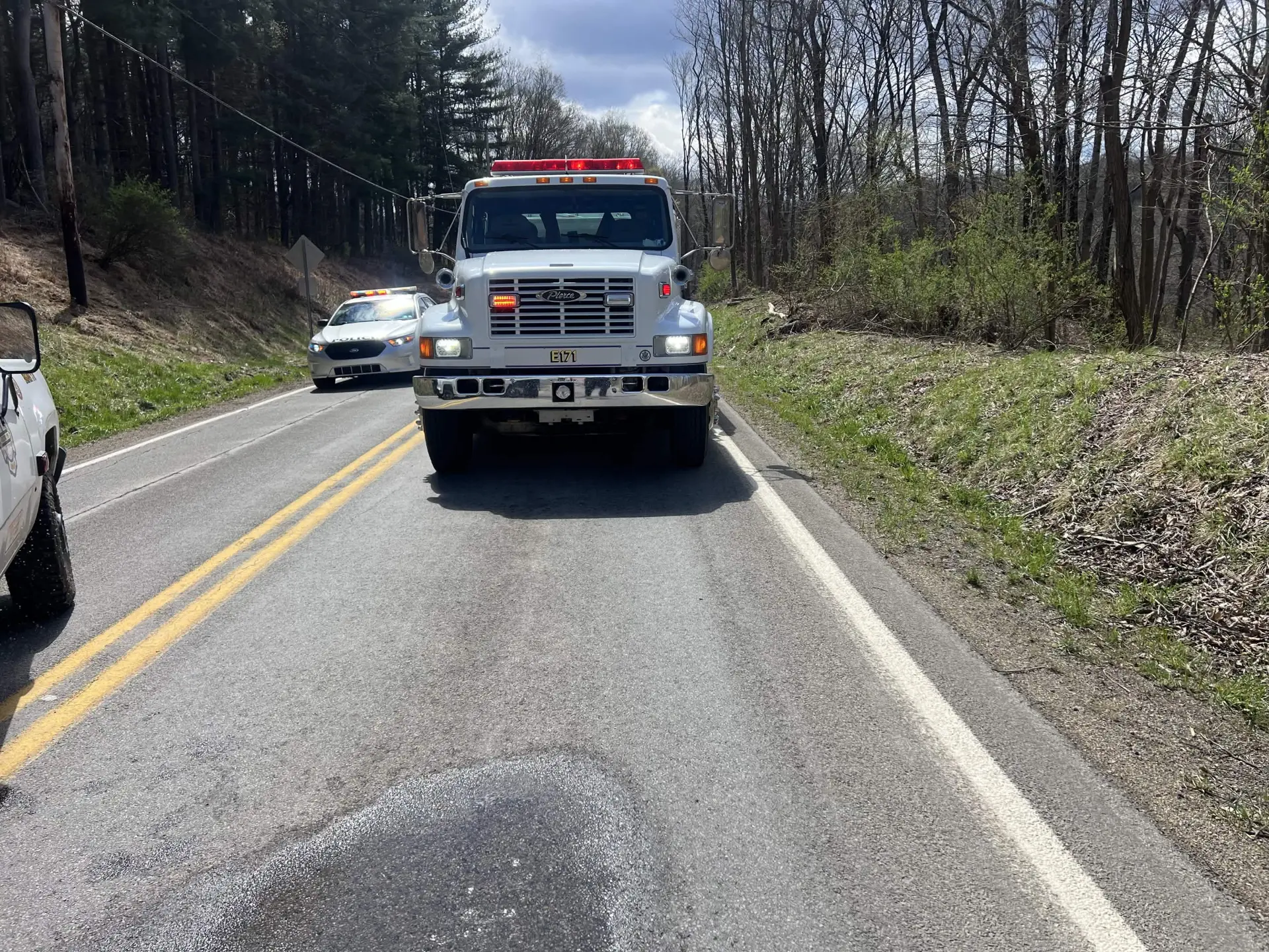 Engine 171 blocking a rural roadway with a police cruiser behind it