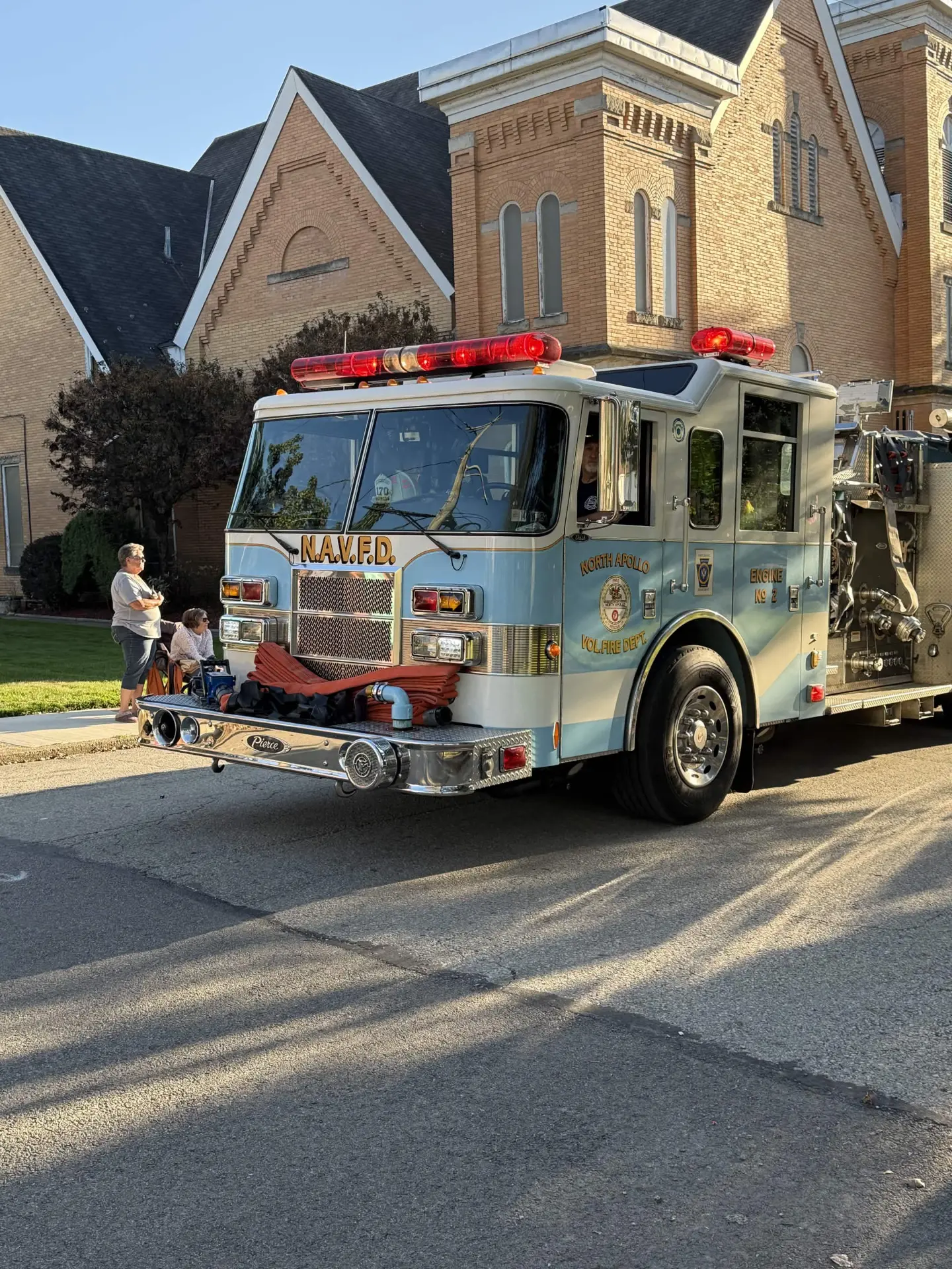 Engine No. 2 parked on the street in front of a brick church